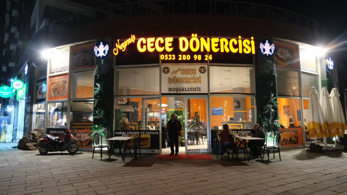 Neymiş Gece Dönercisi'nin gece ışıklı dükkan önü ve açık hava masaları